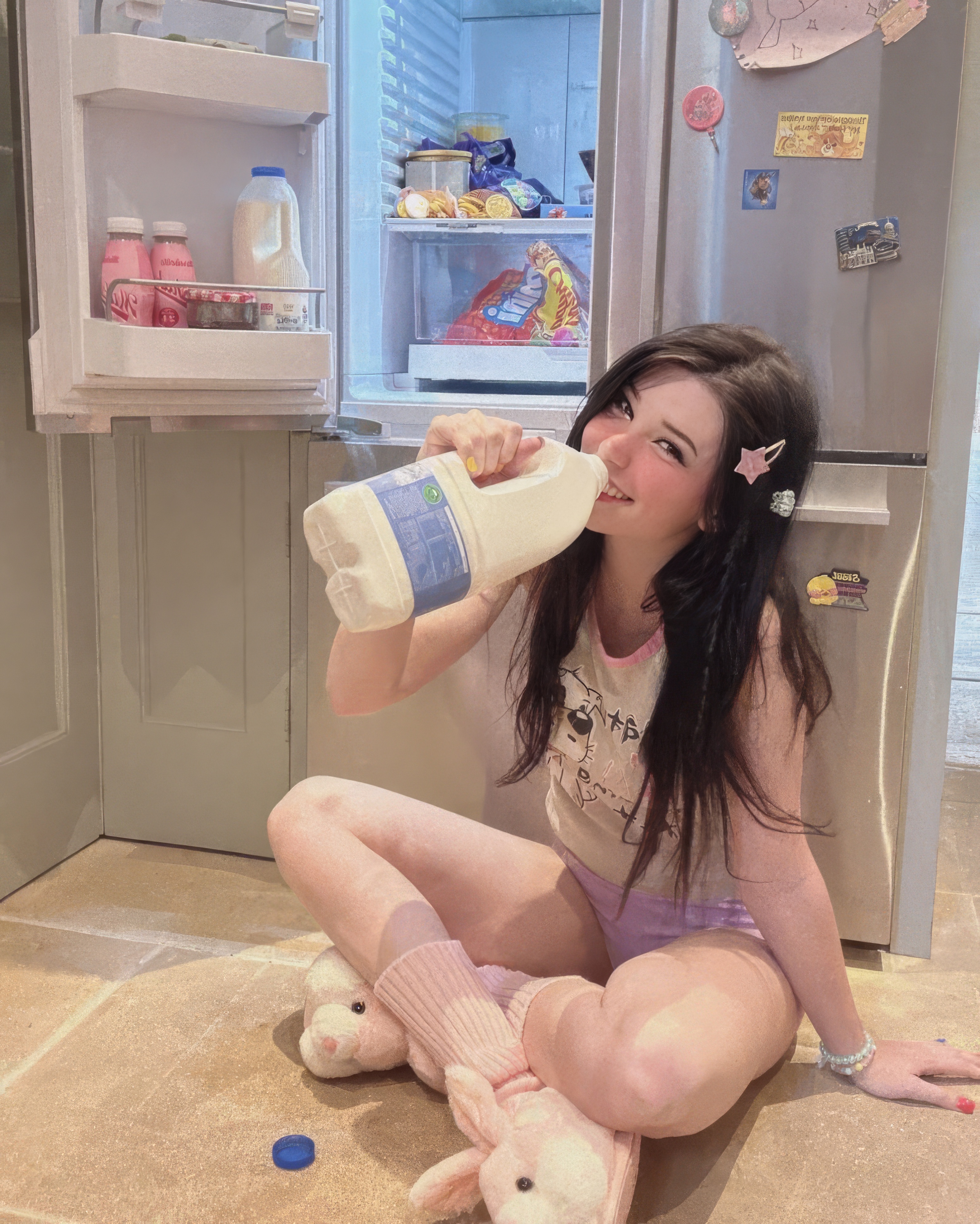 Belle Delphine on the kitchen floor in front of an open fridge, sipping a milk bottle in bunny slippers — the kind of intimate domestic access her highest-tier subscribers were paying to see.